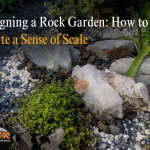 Rock garden with balanced stones and lush greenery, emphasizing scale and design.